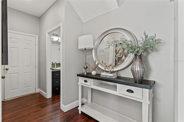 entrance foyer with dark wood finished floors and baseboards