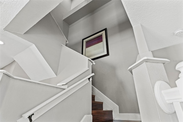 staircase featuring baseboards