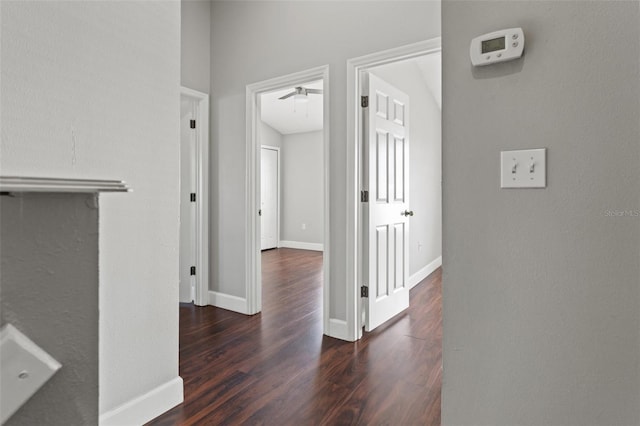 hall featuring wood finished floors and baseboards