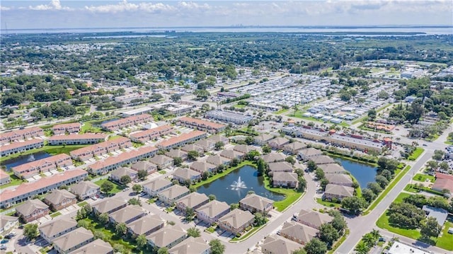 drone / aerial view featuring a water view and a residential view