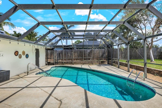 view of pool with a fenced in pool, a lanai, a fenced backyard, and a patio