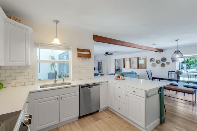 kitchen with a sink, light wood-type flooring, range, a peninsula, and dishwasher