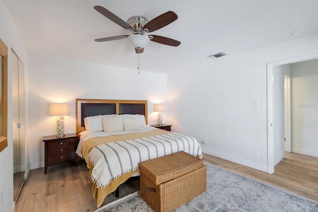 bedroom with light wood-type flooring, visible vents, and baseboards