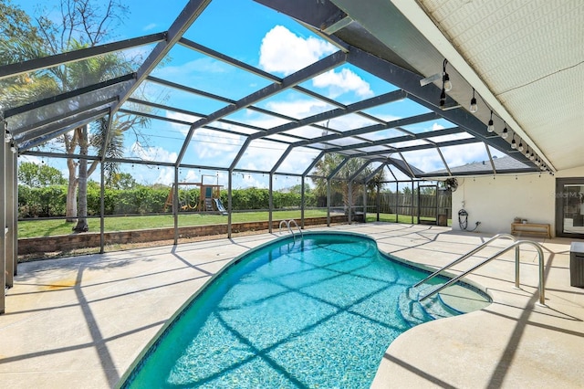 outdoor pool featuring a lanai, a patio area, and fence