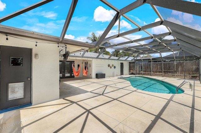 view of swimming pool with a lanai, a fenced in pool, and a patio