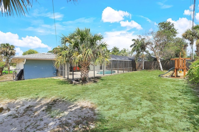 view of yard with a fenced in pool, glass enclosure, a playground, and a fenced backyard