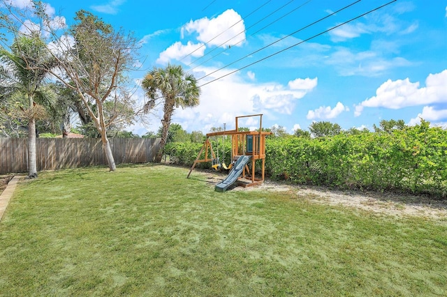 view of yard with a playground and fence