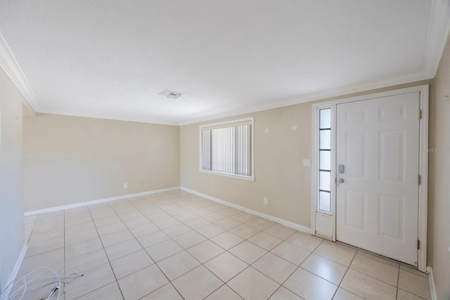 foyer featuring light tile patterned floors, baseboards, visible vents, and ornamental molding