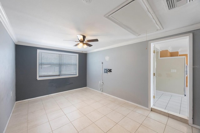 spare room featuring attic access, ornamental molding, baseboards, and light tile patterned floors