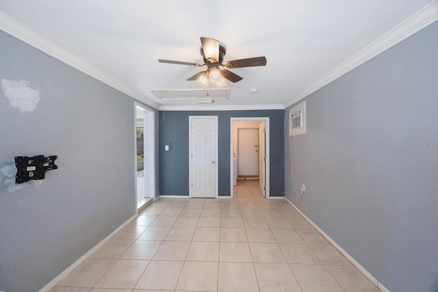 empty room with ornamental molding, light tile patterned flooring, baseboards, and a ceiling fan