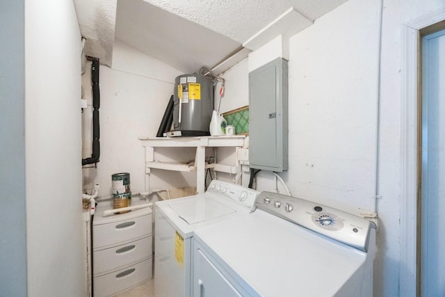 laundry area with washing machine and clothes dryer, electric water heater, a textured ceiling, laundry area, and electric panel