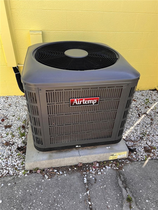 details with central AC unit and concrete block siding