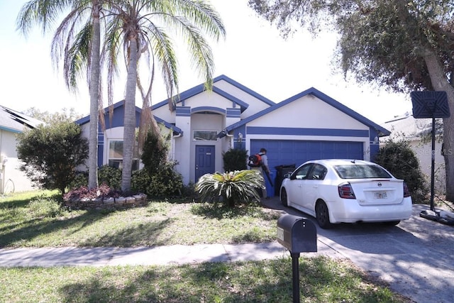 ranch-style house with driveway, an attached garage, and stucco siding