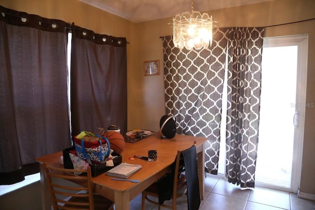 tiled dining area featuring a wealth of natural light and a notable chandelier