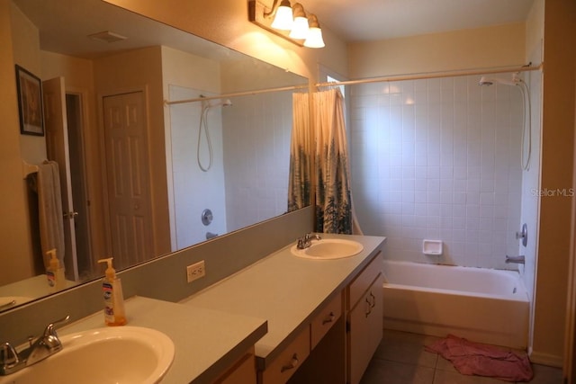 bathroom featuring tile patterned flooring, shower / bath combo, and vanity