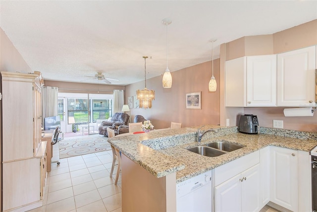 kitchen with dishwasher, open floor plan, a peninsula, white cabinetry, and a sink