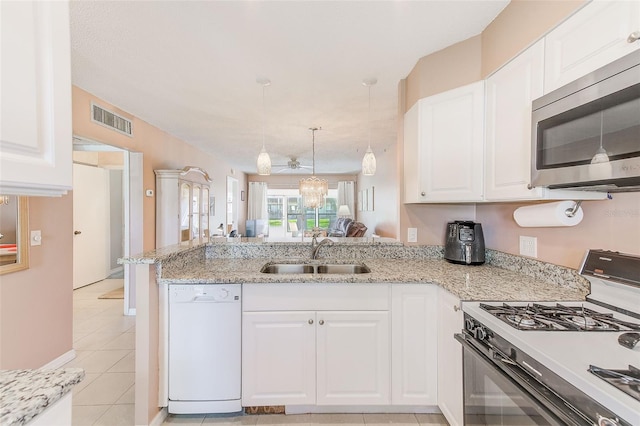 kitchen with range with gas cooktop, stainless steel microwave, visible vents, white dishwasher, and a sink