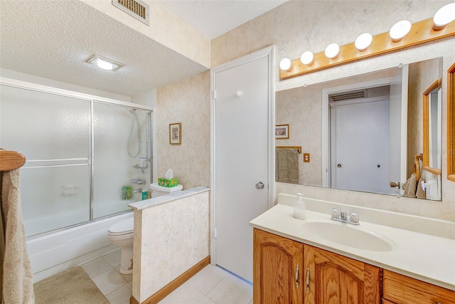 full bathroom featuring visible vents, enclosed tub / shower combo, tile patterned flooring, a textured ceiling, and vanity