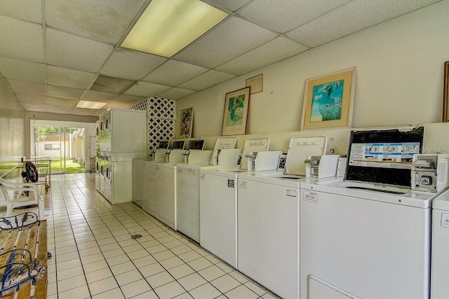 shared laundry area with light tile patterned floors and washer and dryer