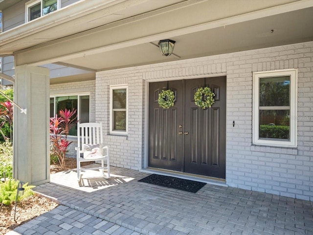 property entrance featuring brick siding