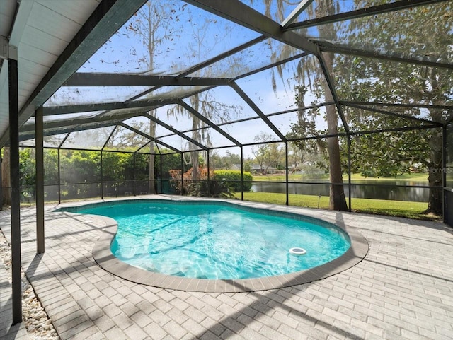 pool featuring a lanai, a water view, and a patio