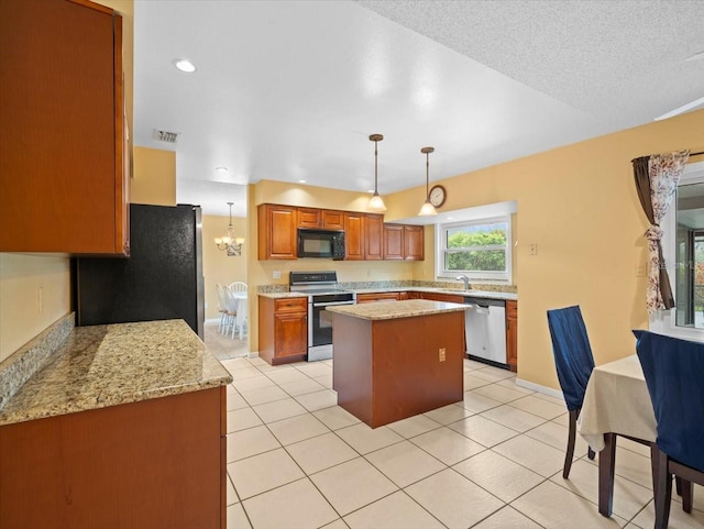 kitchen featuring light tile patterned floors, stainless steel appliances, a center island, brown cabinets, and decorative light fixtures