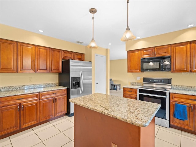 kitchen with light tile patterned floors, stainless steel appliances, brown cabinetry, and visible vents