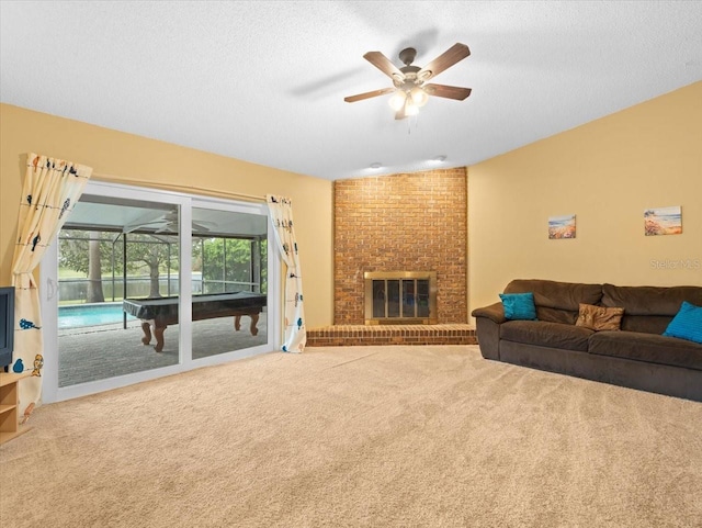 living room with a textured ceiling, a fireplace, and carpet flooring