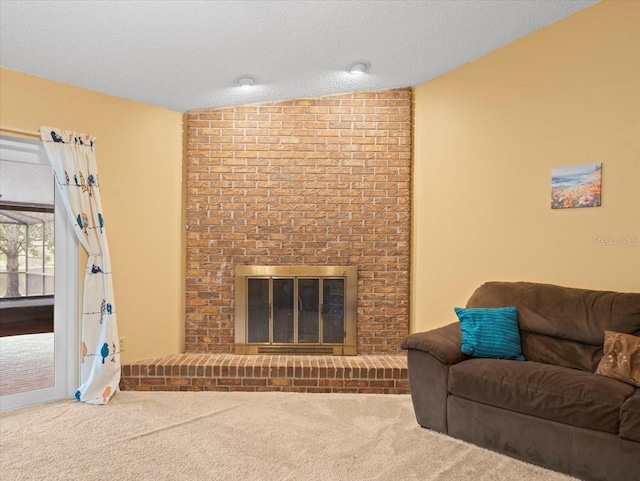 carpeted living area with a fireplace and a textured ceiling