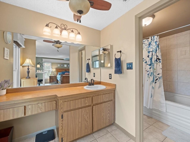 ensuite bathroom featuring a ceiling fan, a textured ceiling, and tile patterned floors