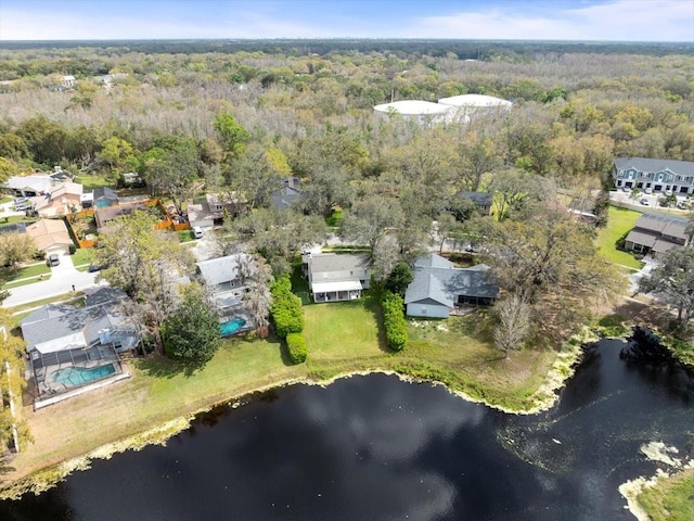 aerial view with a water view and a wooded view