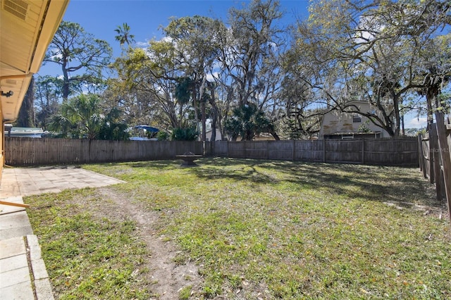 view of yard featuring a patio and a fenced backyard