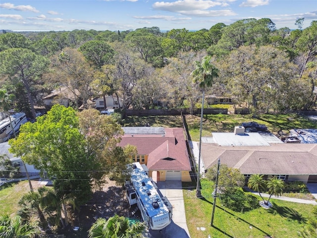 birds eye view of property with a view of trees