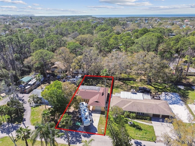 birds eye view of property featuring a wooded view