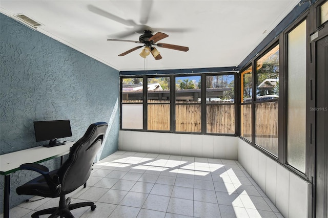 office space with light tile patterned floors, a sunroom, visible vents, a ceiling fan, and ornamental molding