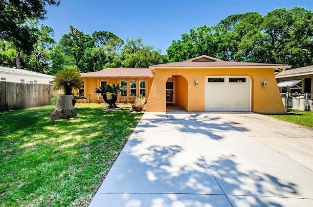 ranch-style house with fence, concrete driveway, a front yard, stucco siding, and an attached garage