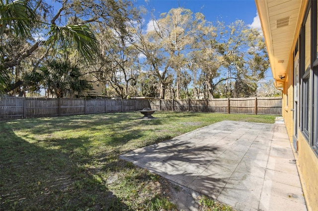 view of yard featuring a patio area and a fenced backyard