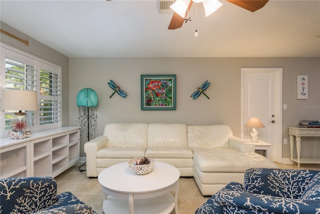 living area with ceiling fan and light tile patterned floors