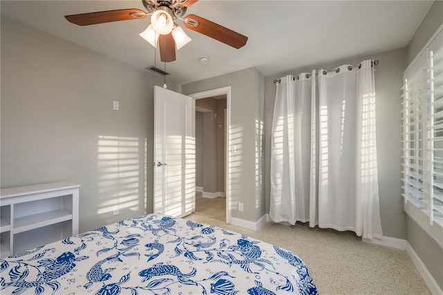 bedroom featuring baseboards and ceiling fan