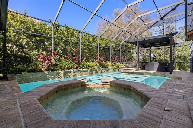 view of pool featuring a lanai, a patio area, and a pool with connected hot tub