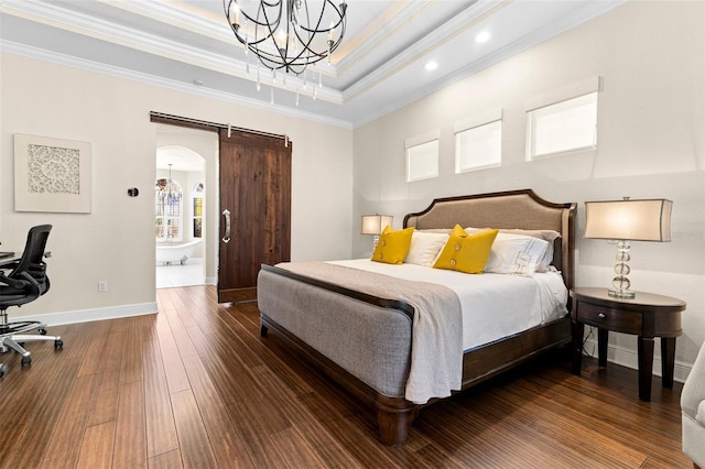 bedroom featuring baseboards, a tray ceiling, dark wood-type flooring, crown molding, and a barn door