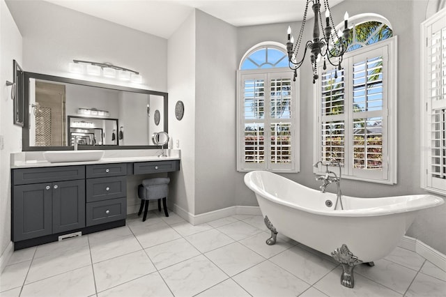 full bath featuring a freestanding tub, baseboards, and vanity