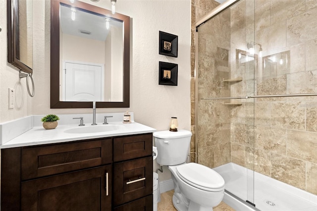 bathroom featuring vanity, a shower stall, toilet, and visible vents