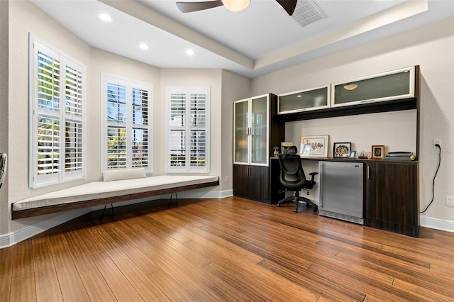 home office with recessed lighting, built in study area, baseboards, and wood finished floors