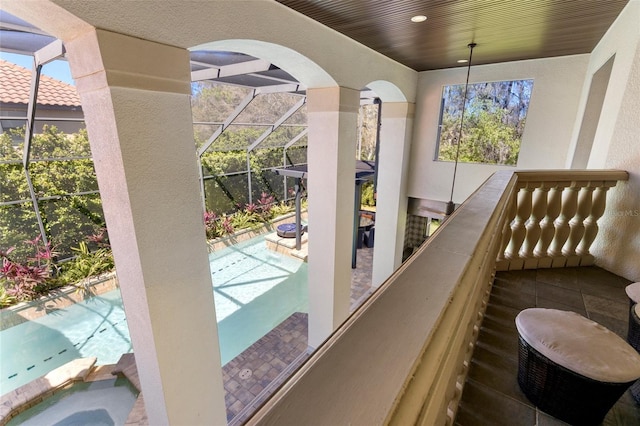 balcony with a pool with connected hot tub