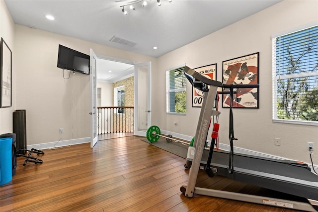 exercise area with recessed lighting, visible vents, wood-type flooring, and baseboards