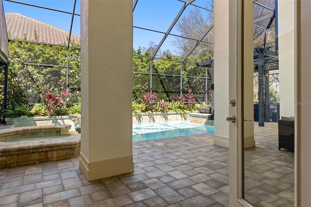 doorway featuring baseboards, brick floor, and a textured wall