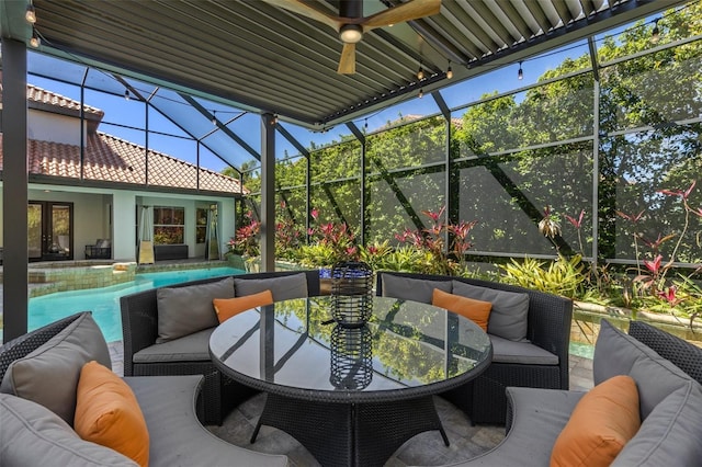 sunroom featuring a ceiling fan