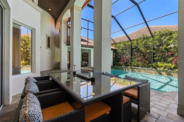 view of patio featuring glass enclosure and an outdoor pool