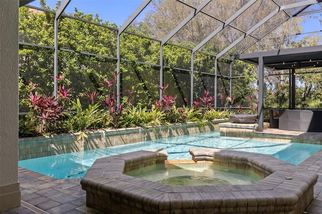 view of pool with a lanai, a pool with connected hot tub, and a patio